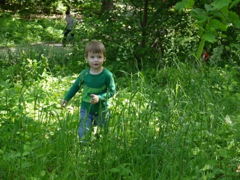 a child walking through tall grass