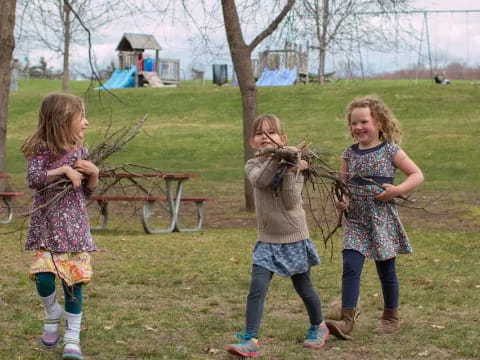 a group of girls standing in a grassy area