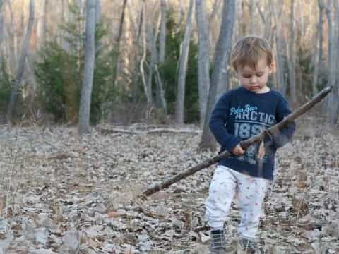 a boy holding a stick