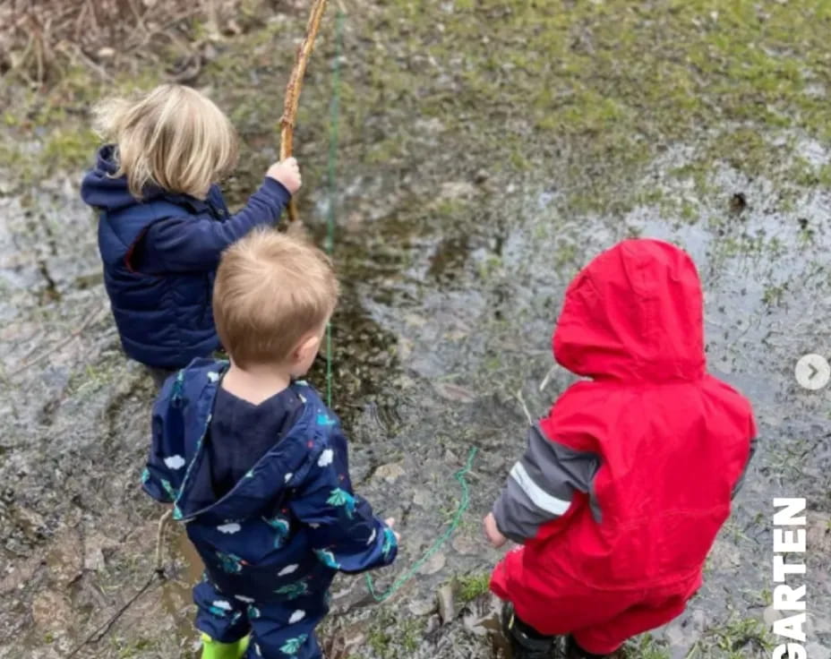 a couple of children holding a stick