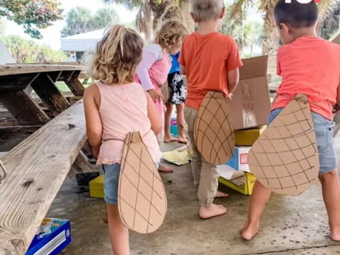 a group of children carrying boxes