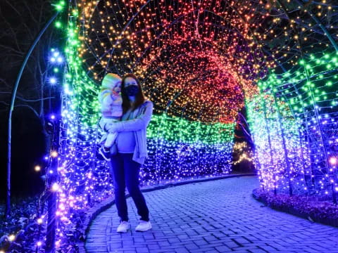 a person standing in front of a wall of lights