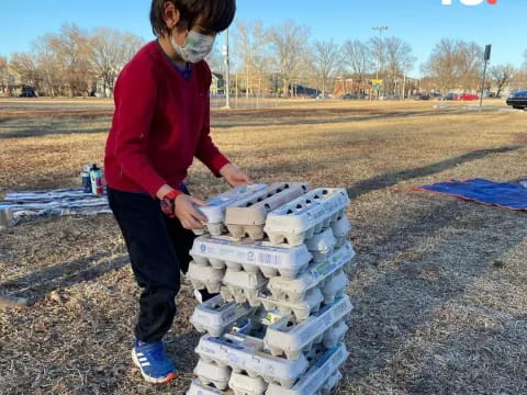 a man standing next to a stack of boxes