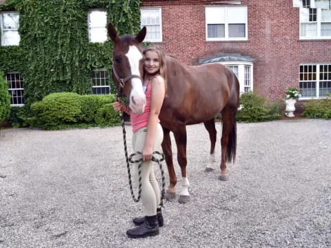 a person standing next to a horse