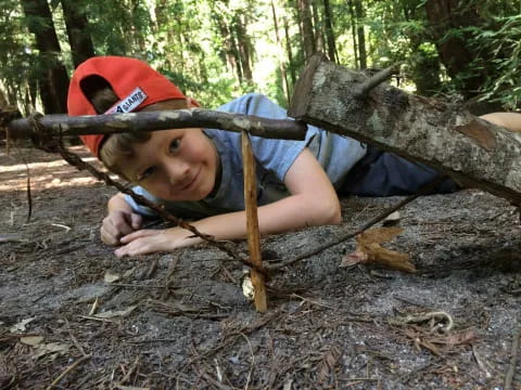 a boy lying on a log