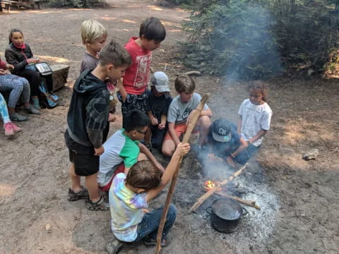 a group of children around a fire