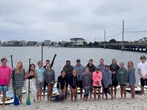 a group of people posing for a photo on a beach