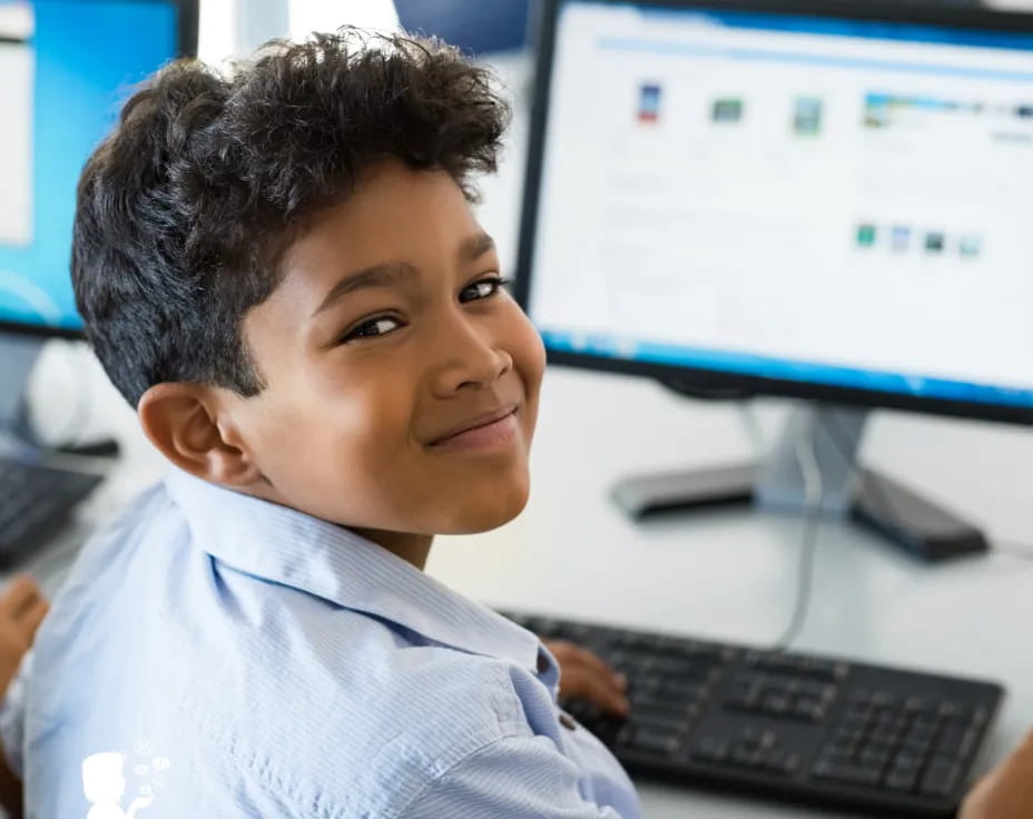a young boy sitting at a computer