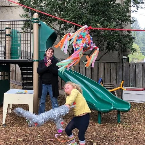 a person and a child playing in a play area