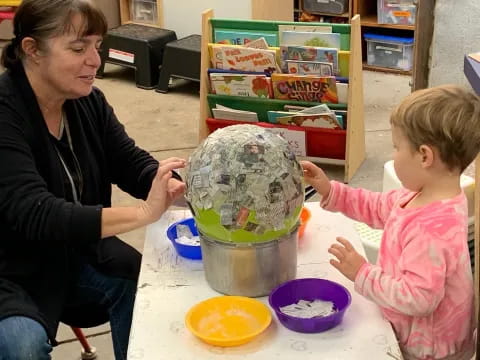 a woman and a child painting