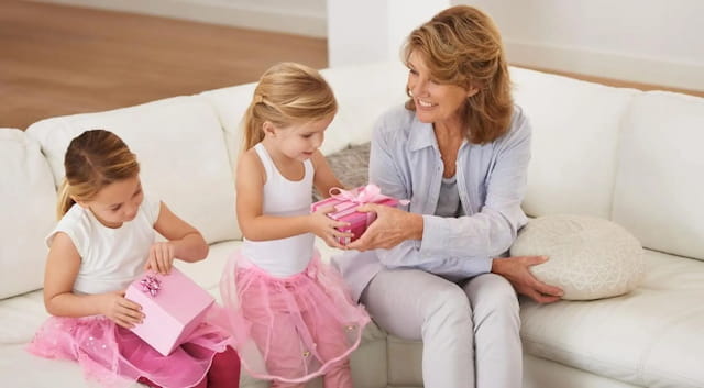 a woman and two children sitting on a couch