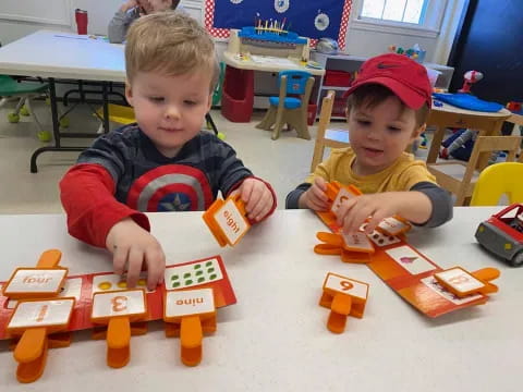 a couple of boys playing with building blocks