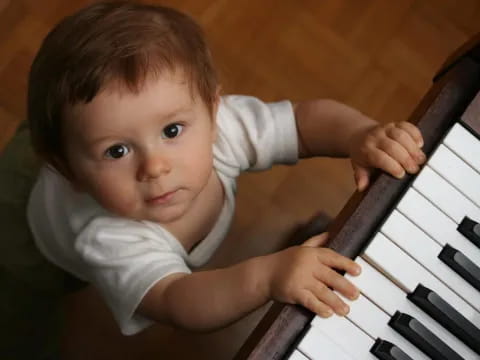 a baby playing a piano