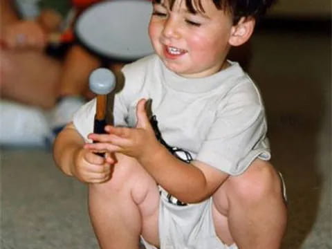 a boy playing with a toy