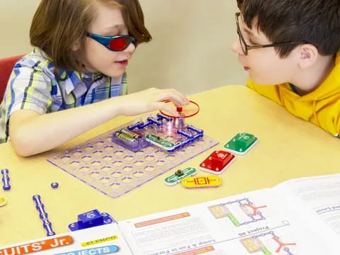 a boy and girl playing a board game