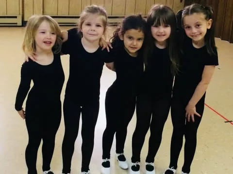 a group of girls wearing black and white ice skates