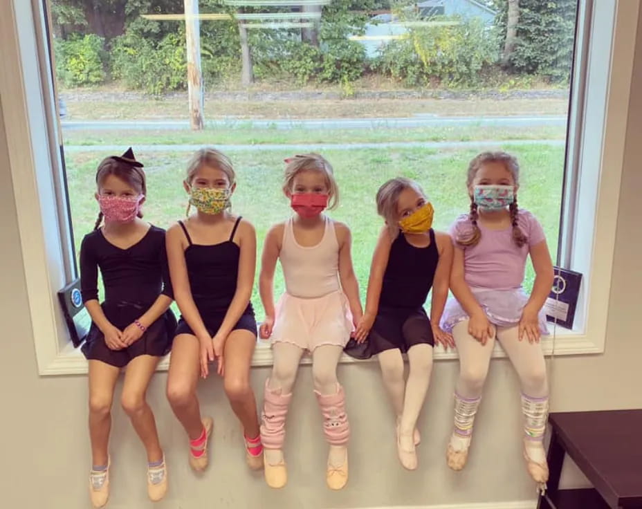 a group of girls wearing masks