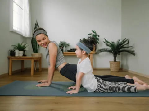 a person and a child doing yoga