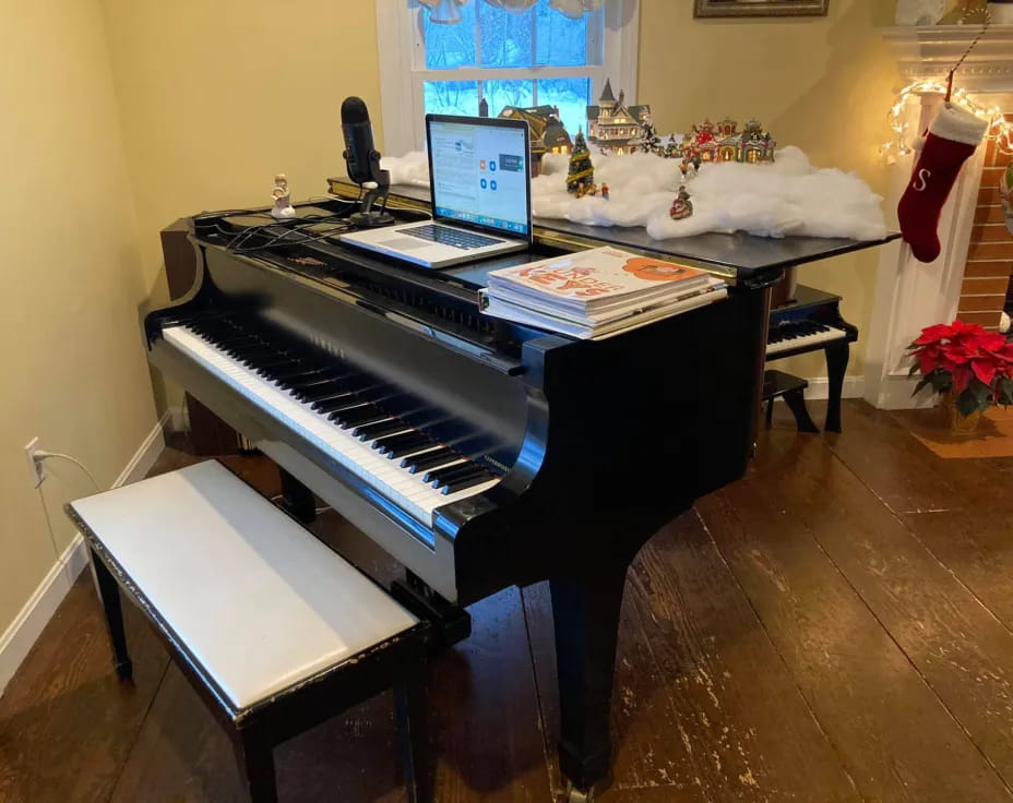 a piano with a laptop on top