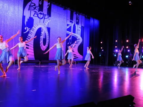 a group of girls dancing on a stage