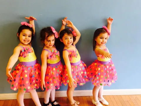 a group of girls in colorful dresses