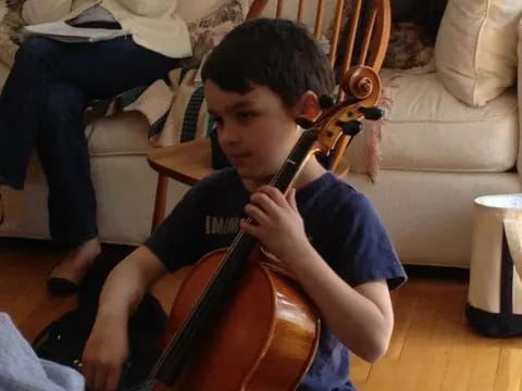 a boy playing a cello