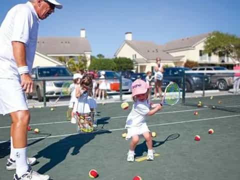 a man and a child playing tennis