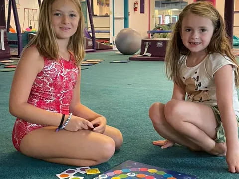 two girls sitting on the floor