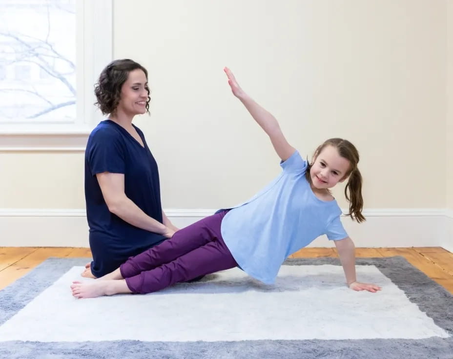 a person and a girl doing yoga