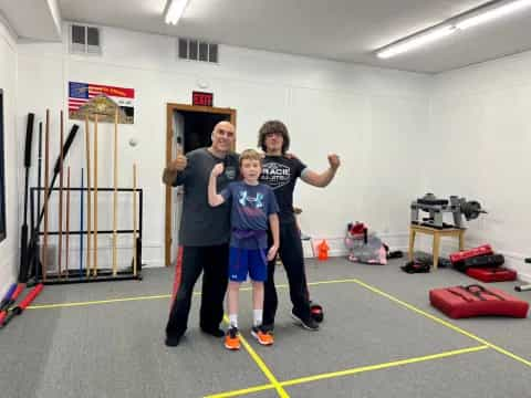 a group of people posing for a photo in a gym