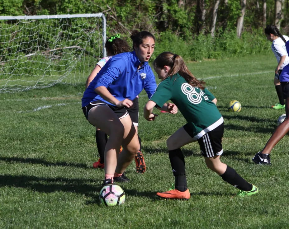 girls playing football on a field