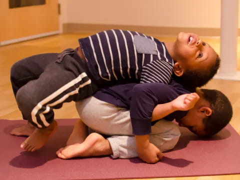 a person and a baby lying on the floor