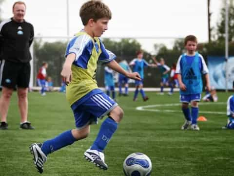 a group of kids playing football