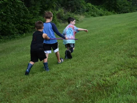 a group of kids playing in the grass