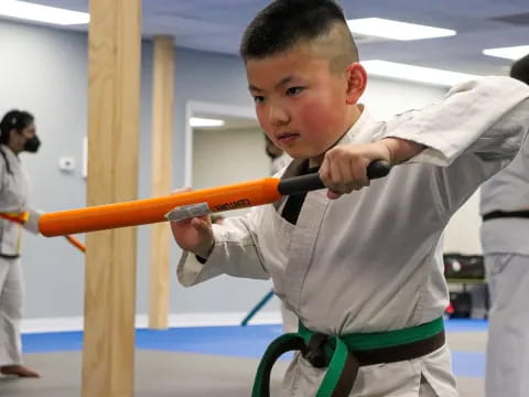 a young boy in a karate uniform