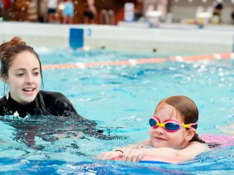 a person and a child in a pool