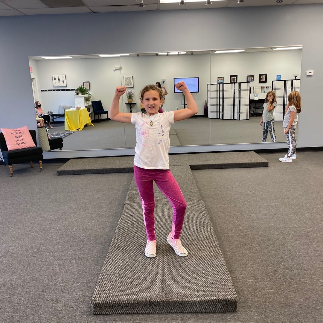 a girl standing on a treadmill