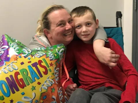 a person and a boy sitting on a couch