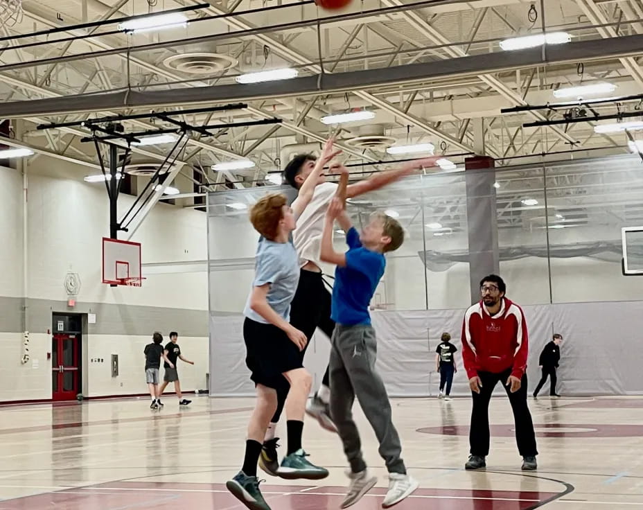 a group of people playing basketball