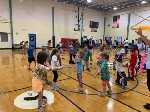 a group of children playing basketball