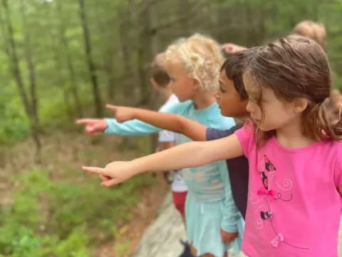 a group of children playing on a path in the woods