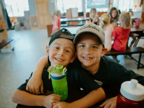 two boys sitting at a table