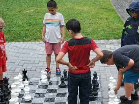 a group of kids playing chess