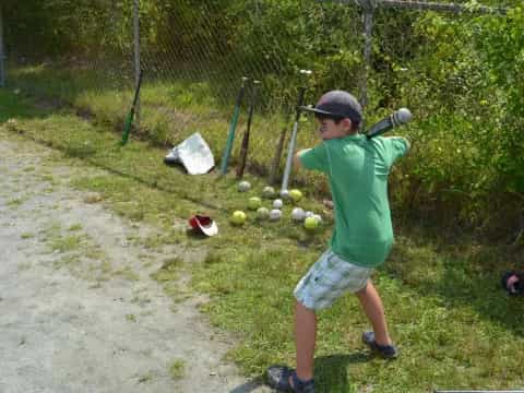 a boy swinging a baseball bat