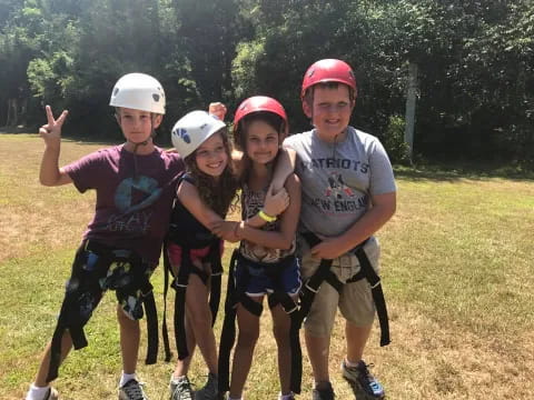 a group of people wearing helmets and posing for the camera