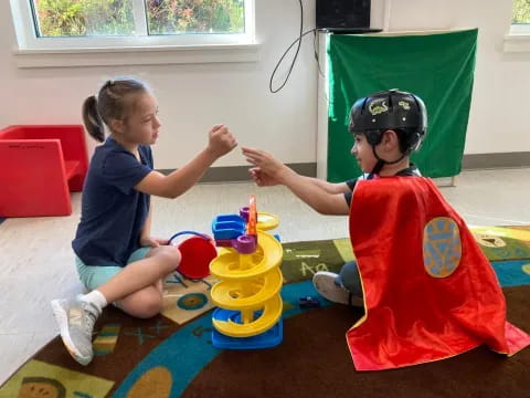 a child and a person playing with toys