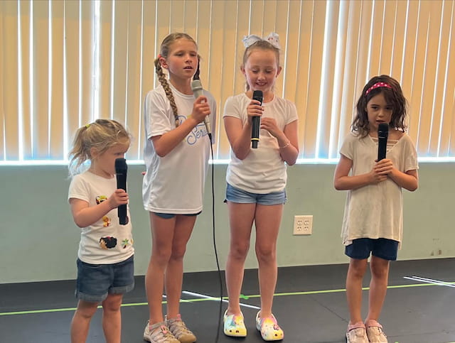 a group of girls holding microphones