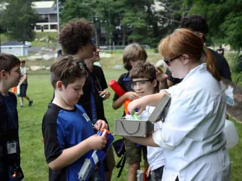 a group of people looking at a box