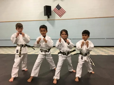 a group of people in karate uniforms