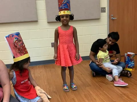 a group of children wearing party hats